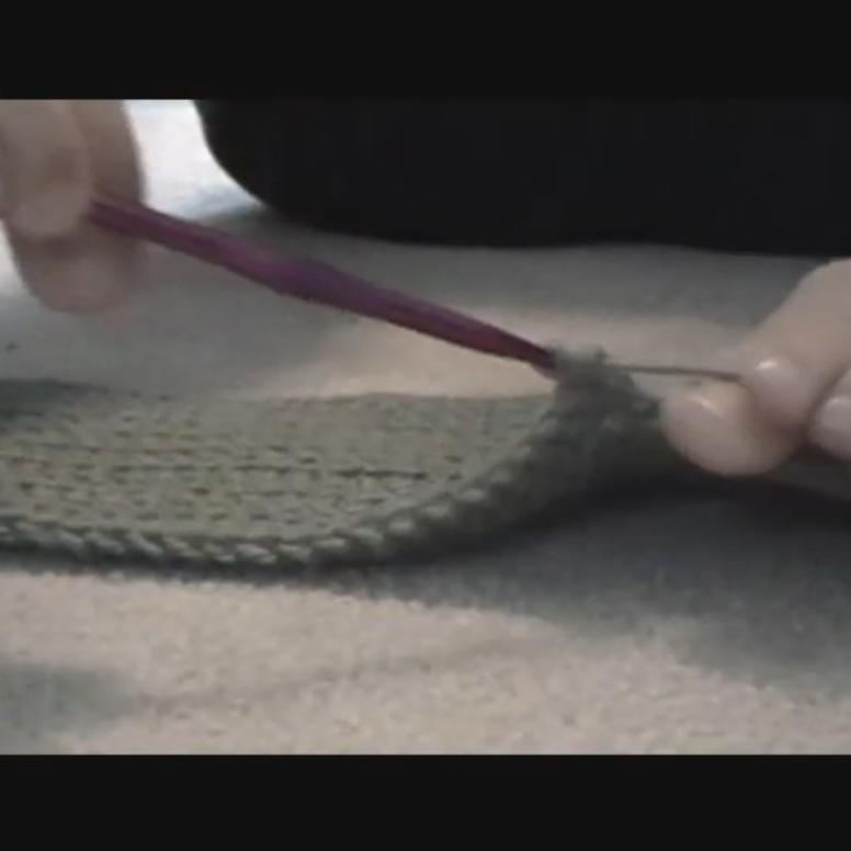 screenshot of Sarah crocheting wtih her feet