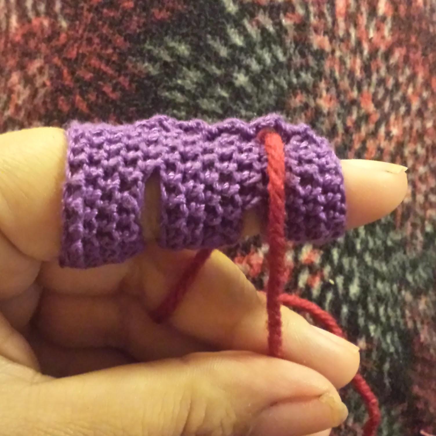 a crochet tube around a finger with working yarn on top of it