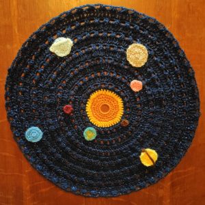 a crochet solar system on a circle